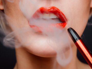 woman with red lipstick and red lipstick Vaping